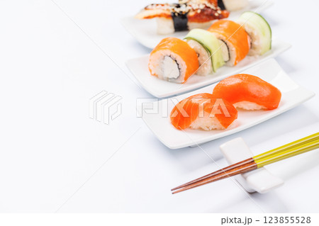 Assorted sushi and maki rolls beautifully arranged on plates 123855528