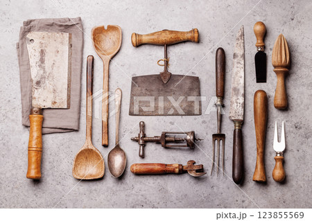 A collection of various retro kitchen and cooking utensils displayed on a table A collection of various retro kitchen and cooking utensils displayed on a table 123855569