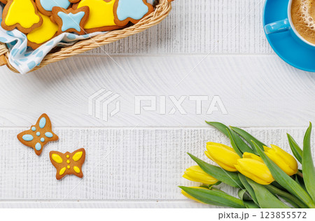 Easter Bunny-Shaped Gingerbread Cookies, Yellow Tulips, and Coffee Cup 123855572