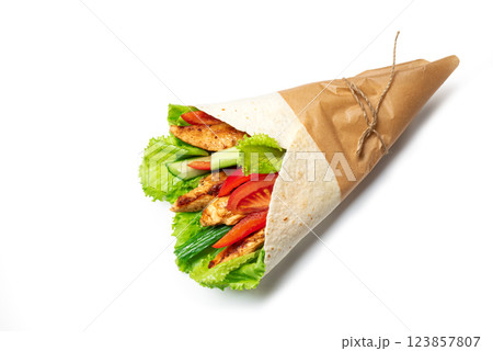Grilled chicken wrap with fresh lettuce, tomatoes and cucumber in tortilla Grilled chicken wrap with fresh lettuce, tomatoes and cucumber in tortilla 123857807