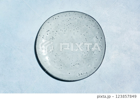Empty blue ceramic plate on blue table 123857849