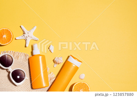 Summer background with UV sunblock products, sunglasses, straw hat Summer background with UV sunblock products, sunglasses, straw hat 123857880