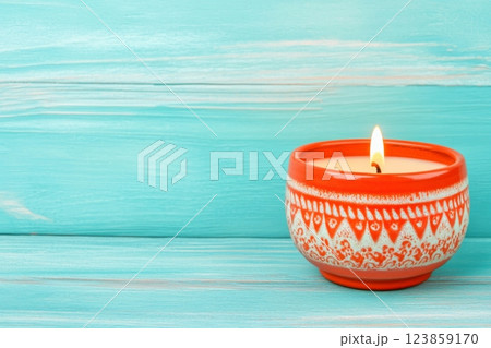 Orange Ceramic Candle Holder on Turquoise Wooden Background 123859170