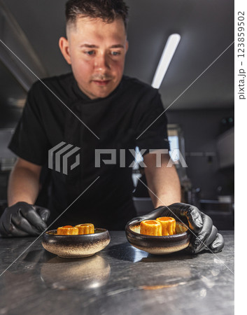 Professional chef plating elegant appetizers Professional chef plating elegant appetizers 123859502
