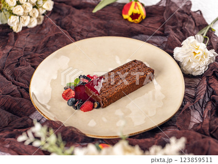 Chocolate cake slice with berry coulis Chocolate cake slice with berry coulis 123859511