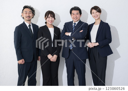 ビジネススーツで複数(4人)笑顔のイメージのカメラ目線　白背景	 123860526
