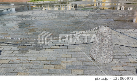 Close-up of the sidewalk fence in the form of granite posts with iron chains Close-up of the sidewalk fence in the form of granite posts with iron chains 123860972