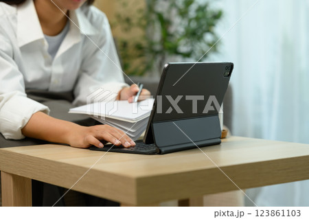 Close up shot unrecognizable woman typing on a digital tablet keyboard 123861103