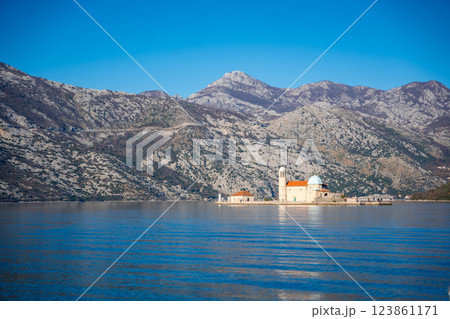 View from yacht boat of Island and Church of Our Lady of the Rocks near Perast in Montenegro. Boka Kotor bay, Europe.  123861171