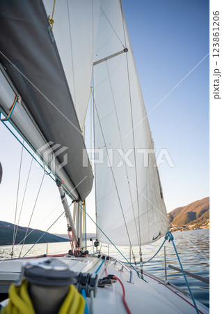 Yacht sailing in Adriatic sea. Close-up view of the deck, mast and sails. Yachting concept Yacht sailing in Adriatic sea. Close-up view of the deck, mast and sails. Yachting concept 123861206