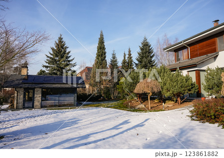 Modern house with solar panels and landscaped garden in winter sunlight Modern house with solar panels and landscaped garden in winter sunlight 123861882