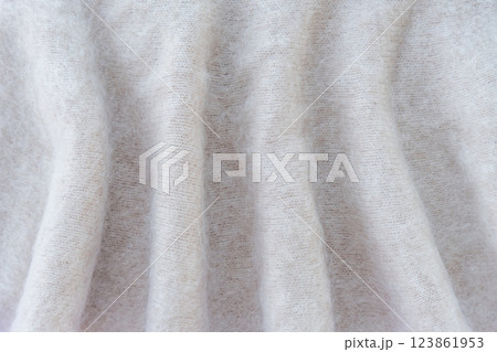 Soft white mohair wool fabric with delicate folds Soft white mohair wool fabric with delicate folds 123861953
