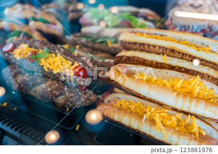 Fresh white and whole grain panini sandwich with cheddar cheese, cherry tomatoes in a bakery display Fresh white and whole grain panini sandwich with cheddar cheese, cherry tomatoes in a bakery display 123861976
