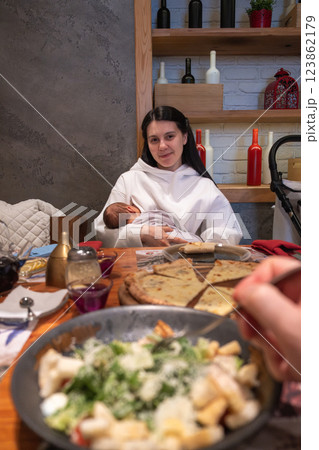 Cozy Family Dining with Breastfeeding Mother 123862179