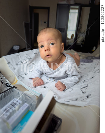 Curious Baby on dipper changing table with Animal Print Blankets Curious Baby on dipper changing table with Animal Print Blankets 123862227