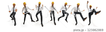 Playful construction engineer in white shirt and yellow helmet joyfully moving with rolled-up blueprints, showcasing enthusiasm. 123862869