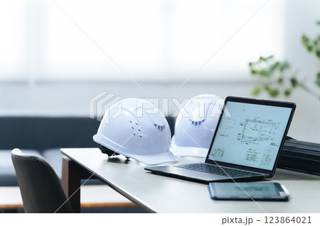 オフィスに置かれたノートパソコンとヘルメット 123864021