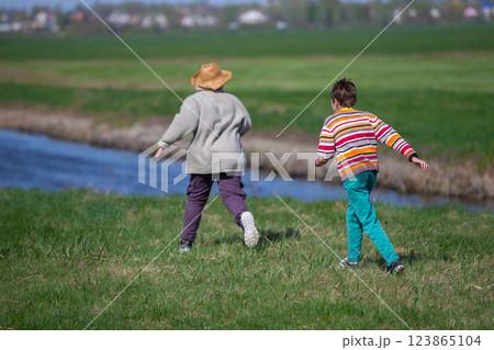 Two boys running after each other in nature. Children on summer holidays. Two boys running after each other in nature. Children on summer holidays. 123865104