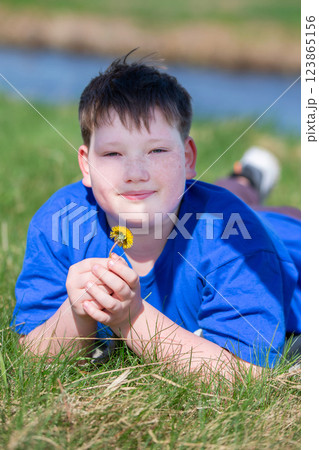 Portrait of a teenage boy against a background of nature. 123865156