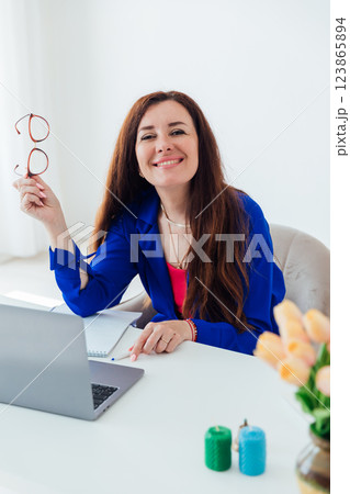woman smiling at laptop studying in office online 123865894