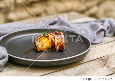 Chef preparing traditional Provencal vegetable dish Ratatouille with stuffed rolled meat on the grill. French food. Healthy eating Chef preparing traditional Provencal vegetable dish Ratatouille with stuffed rolled meat on the grill. French food. Healthy eating 123865987