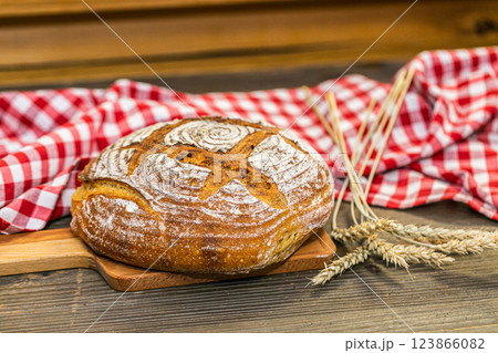 Handmade fresh bread baked with natural ingredients on a wooden board. Handmade fresh bread baked with natural ingredients on a wooden board. 123866082