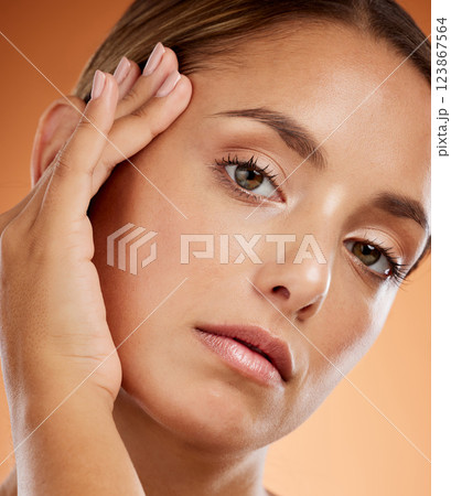 Woman, beauty and skincare facial in cosmetic, makeup and hand for treatment against a studio background. Closeup portrait of beautiful female model isolated with face cosmetics and care for skin 123867564