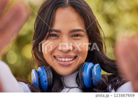Selfie portrait of young Indian woman, happy outdoor freedom and weekend lifestyle in Indonesia. Gen z hipster girl streaming podcast, video call of face or relax smile in nature with cool music Selfie portrait of young Indian woman, happy outdoor freedom and weekend lifestyle in Indonesia. Gen z hipster girl streaming podcast, video call of face or relax smile in nature with cool music 123867609