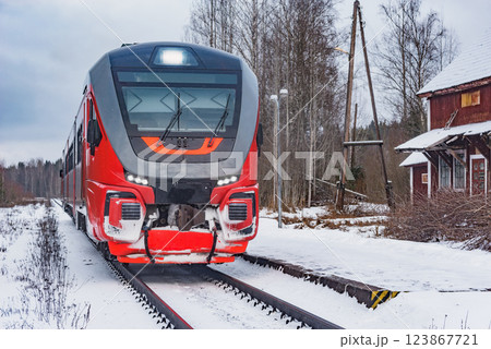 Passenger diesel train stands by the platform at winter morning. 123867721
