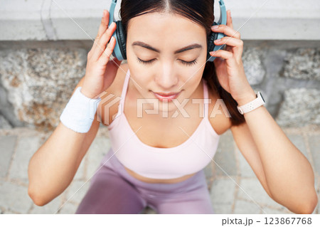 Yoga, headphones and woman listening to music for zen, calm and peace meditation in the city. Health, fitness and girl from Canada doing a pilates exercise with wellness audio, podcast or radio. Yoga, headphones and woman listening to music for zen, calm and peace meditation in the city. Health, fitness and girl from Canada doing a pilates exercise with wellness audio, podcast or radio. 123867768