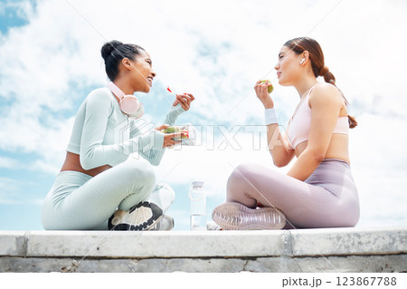 Salad, apple and fitness friends eating food outdoor for wellness, diet and vegan lifestyle with blue sky clouds mock up. Women or people with green fruits and vegetables lunch after an exercise Salad, apple and fitness friends eating food outdoor for wellness, diet and vegan lifestyle with blue sky clouds mock up. Women or people with green fruits and vegetables lunch after an exercise 123867788