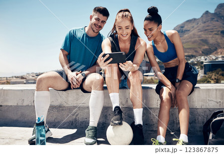 Sports, social media and friends with phone and relax after football training, fitness and workout. Summer, internet and technology with athlete and soccer ball for exercise, health and wellness 123867875