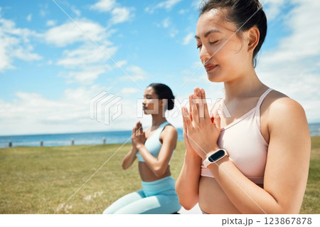 Fitness, yoga and woman in spiritual wellness, exercise and training workout for mental wellbeing in nature. Women in meditation pose on grass in calm, peace and zen for healthy mind, body and spirit 123867878