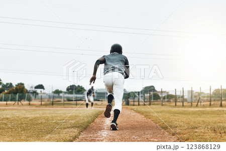 Baseball player, running and sports pitch with athlete with fast energy doing base run at game or match on a sport field. Fitness, exercise and training workout with sport runner male outdoor 123868129