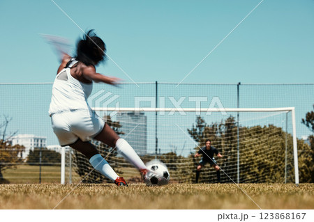 Woman, score and net for goal in soccer, training and sports on field for fitness, health and exercise. Girl, football and kick, aim and workout on grass for sport in summer, sunshine and game 123868167
