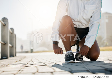 Shoes tie, sport and woman outdoor running for athlete exercise, workout and a summer run. Sports, runner training and health wellness cardio of a fitness person busy with healthy lifestyle practice 123868336