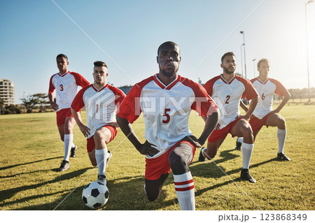 Soccer, men and team stretching on field before sports game or training exercise. Health, fitness and teamwork, football competition players stretch on grass together for strong performance in match. 123868349