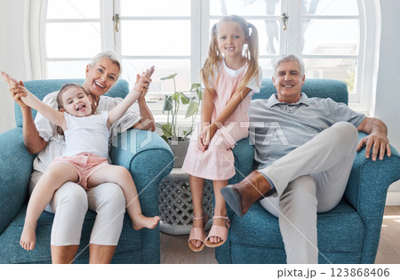 Happy grandparents, children and smile in relax for family bonding time together in the living room at home. Portrait of grandma, grandpa and little girls smiling in playful happiness for free time 123868406