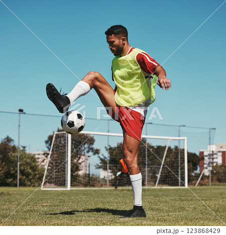 Soccer, training and man with ball on soccer field for fitness, workout and sports practice. Football, energy and skill by professional athlete enjoy sport routine with soccer ball at football field Soccer, training and man with ball on soccer field for fitness, workout and sports practice. Football, energy and skill by professional athlete enjoy sport routine with soccer ball at football field 123868429