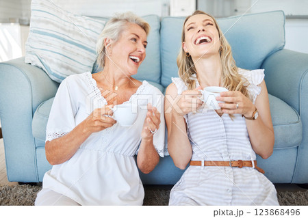 Coffee, mother and daughter with comic communication together on the living room floor of their house. Funny, happy and elderly mom with her child, tea and conversation in the lounge of their home 123868496