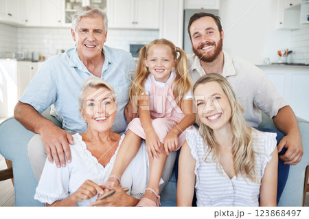 Family, happy and together, love and bonding in portrait in the family home. Grandparent, parent and young girl, generation and spending quality time, happiness and smile on sofa in living room. 123868497