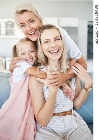 Portrait of grandmother, mother and girl child with smile sitting on sofa to relax, bond and hug. Happy grandma, mom and kid relaxing on couch together in living room of the family home in Australia. 123868498