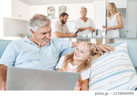 Laptop, child and grandfather with comic video on the Internet and the living room sofa of their house. Girl with smile for subscription service on tech with funny movies and an elderly man 123868499