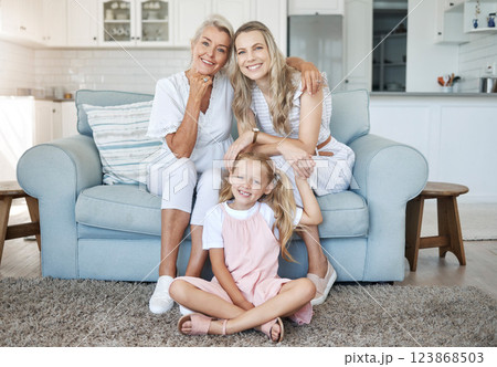Mom, child and grandmother portrait on sofa for female generations in happy family relaxing. Love, care and bond of women relatives with smile at living room couch together at home in Canada. Mom, child and grandmother portrait on sofa for female generations in happy family relaxing. Love, care and bond of women relatives with smile at living room couch together at home in Canada. 123868503