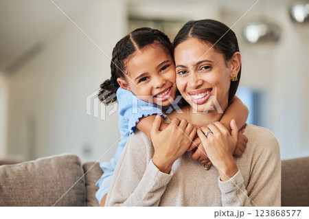 Love, relax and mother and girl on sofa with hug for family, happy and lifestyle together. Smile, support and trust with portrait of mom and child in living room at home for care, youth and happiness 123868577