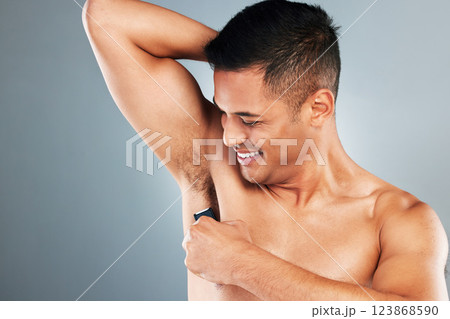 Man, electric shaving and armpit hair removal for skincare, clean body health and aesthetic wellness cosmetics on grey studio background. Happy guy grooming underarm, razor trimmer and fresh hygiene 123868590