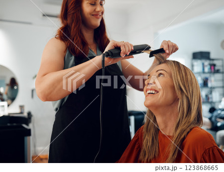 Beauty, hair and hair straightener with woman in hair salon for wellness, makeover and hair care. Stylist, hairdresser and styling for mature lady enjoying pamper, glamour and keratin treatment 123868665