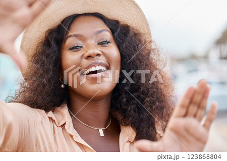 Black woman, portrait smile and travel hands for picture perfect day on summer vacation in the outdoors. Face of happy African female traveler smiling with hand frame for capture or photography Black woman, portrait smile and travel hands for picture perfect day on summer vacation in the outdoors. Face of happy African female traveler smiling with hand frame for capture or photography 123868804