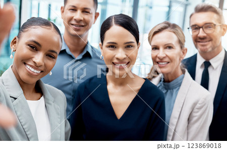 Selfie, office and diversity, business people or team standing in corporate workplace together. Portrait, trust and friends, colleagues or group take picture for happy memory after boardroom meeting. 123869018