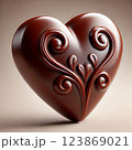 An exquisite chocolate heart with a luxurious bas-relief pattern of swirling ornaments and leaves 123869021